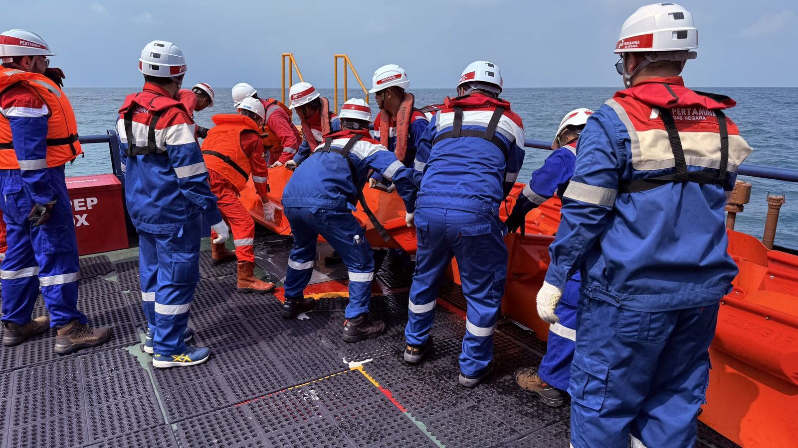 Oil spill response exercise with containment boom deployment on vessel deck
